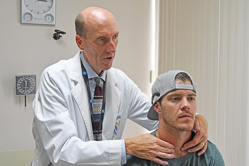 Dr. Michelsen examines a patient during a medical examination in July.