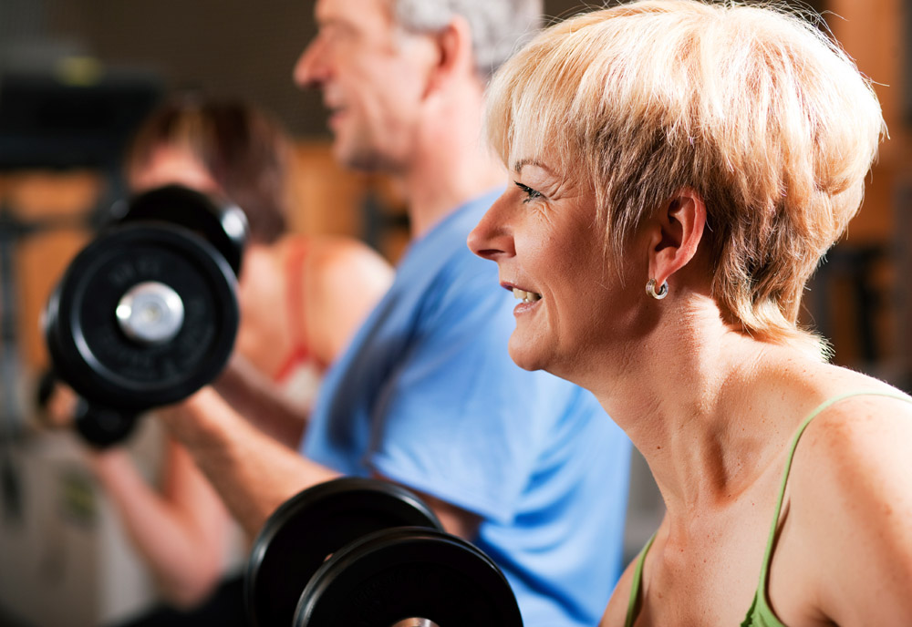 Seniors lift weights at a gym