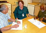 Karen Duddy, Occupational Therapy Supervisor, and Veterans Bill Armstrong  and Olester McNary participate in Doc Talk- a game in which Veterans learn to better communicate with health care providers.