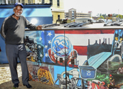 Veteran Charles Yeager standing next to his award winning mural