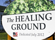 Sign in front of the garden with the words the healing ground dedicated July 2012