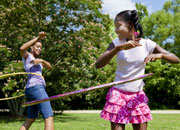 mother and daughter using hula hoops