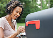 Woman checking a mailbox