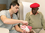 Doctor shows a Veteran a model of the heart