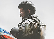 a soldier in profile by a U.S. flag