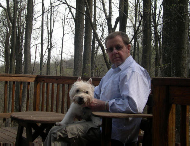 Alan Campbell sittin on deck with dog