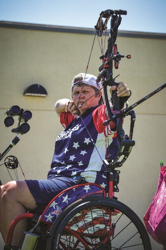 Lia Coryell holidng arrow at Wheelchair Games