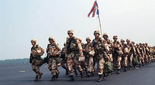 Soldiers in desert camo uniforms marching