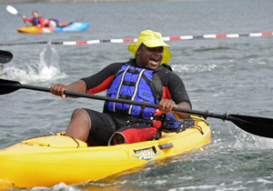 A man laughs while kayaking