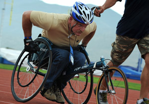 A Veteran pushing with effort in a wheelchair race
