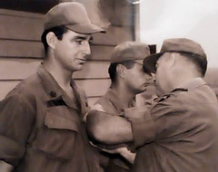 Servicemember Sam Powell receives a medal in military uniform
