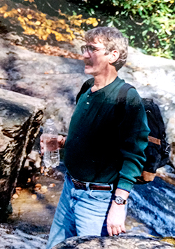 Roy Jeffers hiking in a rocky wooded area