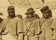 African American soldiers from the Civil War stand outside a tent