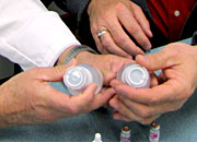 Hands holding medicine bottles