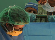 faces of three surgeons looking down