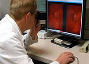 Doctor looking at an image of an eye on a computer