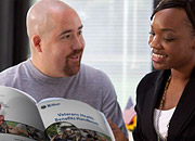 man and woman looking at a brochure
