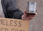 Homeless man begs for money and food on an alleyway corner