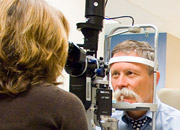 Physician uses equipment to examine a Veteran's eye