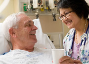 Nurse helping a Veteran in a hospital bed