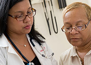 Woman doctor talking with senior female patient