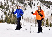 A Veteran and his physical therapist cross country skiing on a mountain.