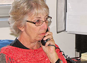 A woman talks on the phone in an office