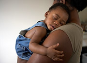 Woman holding a sleeping toddler