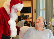 Santa visits with a Veteran in a wheelchair