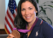 Portrait of a woman holding a bronze Olympic medal