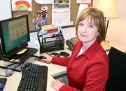 A woman at a call center desk smiles