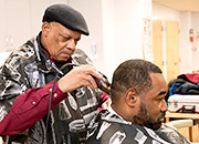 A homeless man receives a haircut