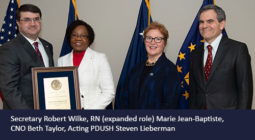 Marie Jean-Baptiste receives award from Secretary Wilke