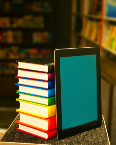 Stack of books with a tablet computer