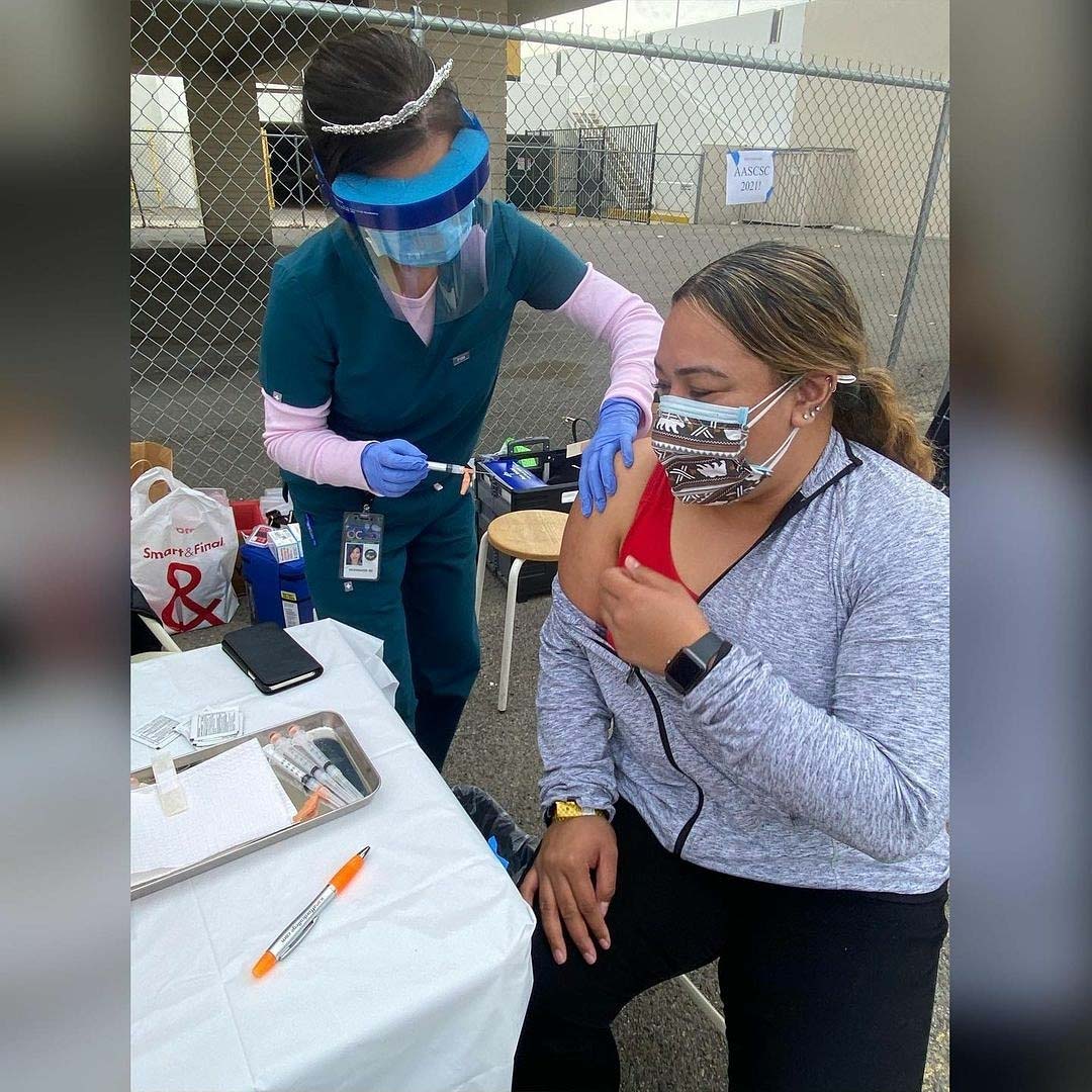 PHOTO: Hispanic female getting vaccinated.