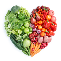 red, orange, and green vegetables arranged in a heart shape