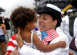 U.S. navy woman holding a child
