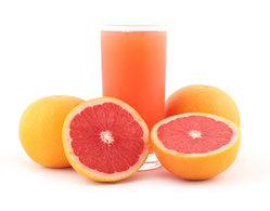 grapefruit sliced in half, glass of grapefruit juice