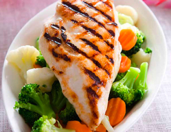dinner plate containing steamed vegetables and grilled chicken