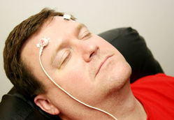 man with biofeedback monitors attached to forehead