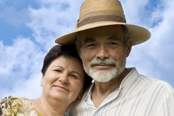 man wearing hat with arm wrapped around woman's shoulders