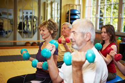 people exercising with hand weights