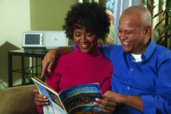African American couple looking at a magazine with a pd cycler in the background