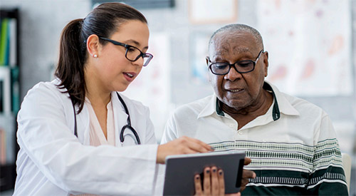 provider explaining report to older man of color