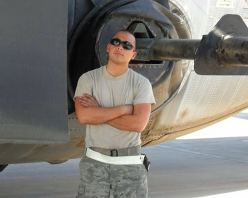 Air Force Engine Mechanic Stephen Jacinto in Iraq with the plane he was responsible for keeping in the air, the AC-130 gunship.