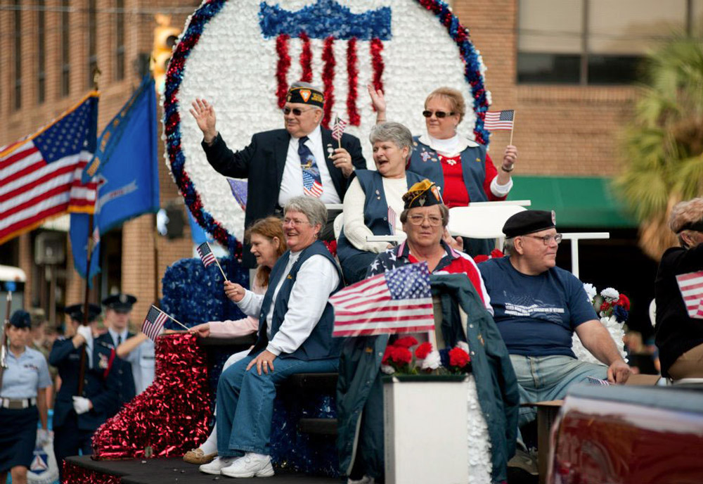 Veterans riding on a parade float.