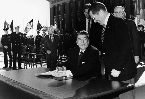 President Reagan signing of Department of Veterans Affairs Act HR 3471 at the National Defense University in Fort McNair, Virginia on October 25, 1988, elevating VA to a cabinet-level executive department.