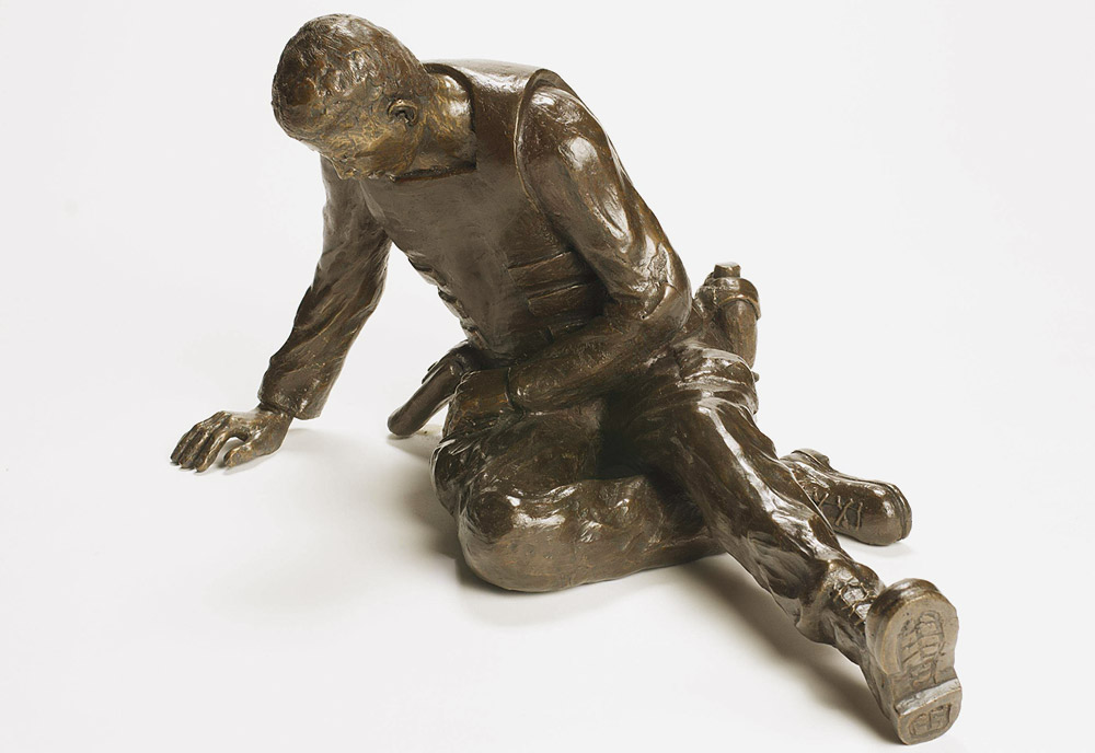 Bronze sculpture of a soldier seated