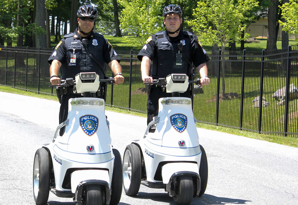 two police officers riding electric scooters
