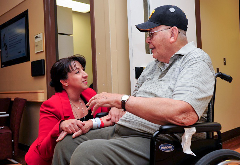 Nurse talking with a patient in a wheelchair